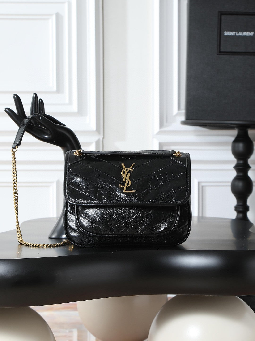 Saint Laurent Niki Baby shoulder bag in black crinkled glossed-leather