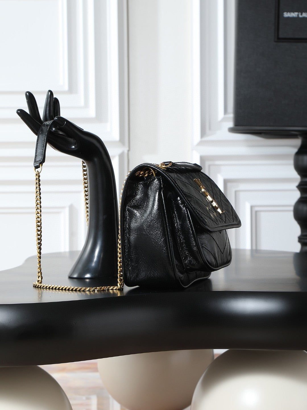 Saint Laurent Niki Baby shoulder bag in black crinkled glossed-leather