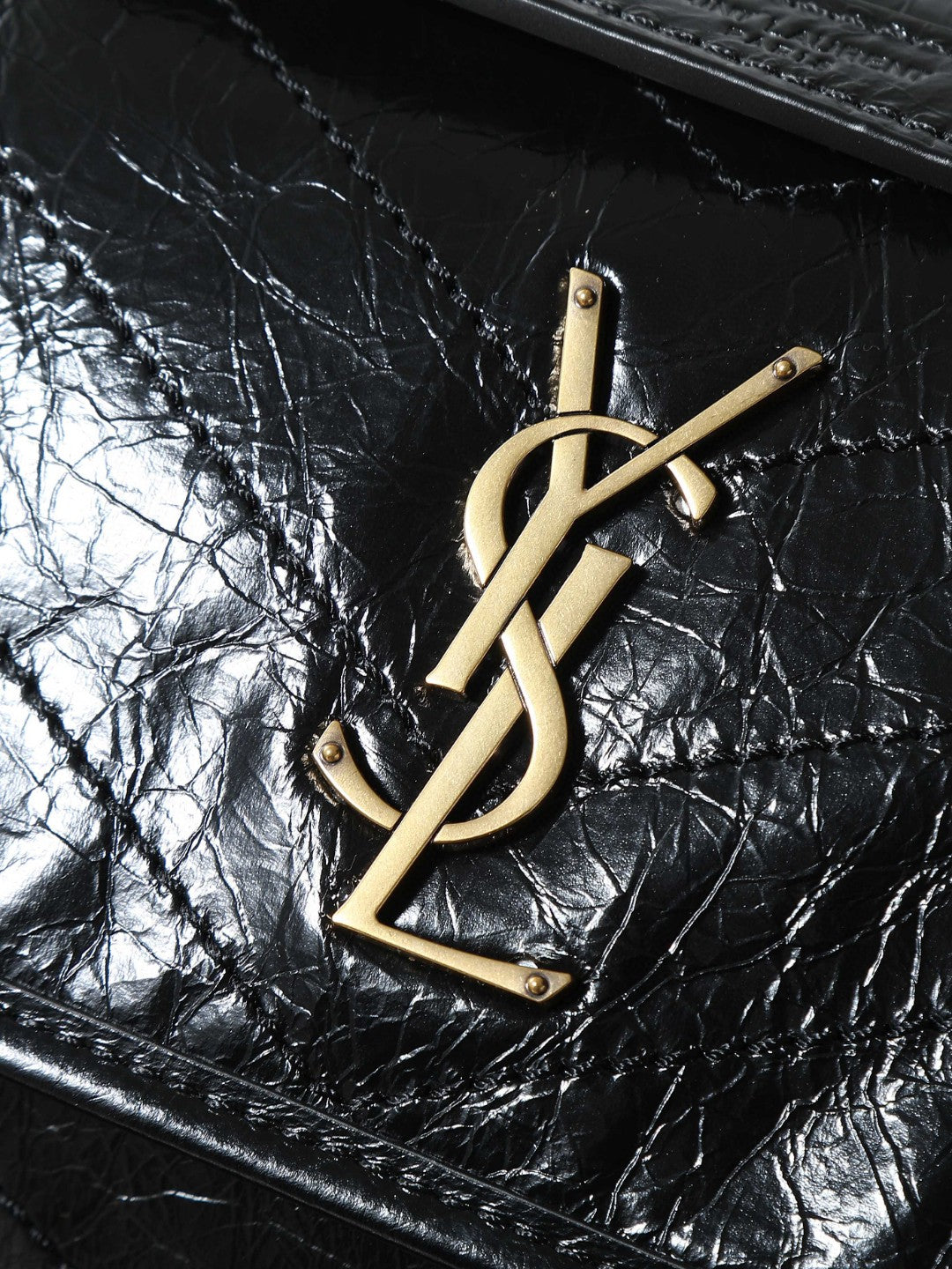 Saint Laurent Niki Baby shoulder bag in black crinkled glossed-leather