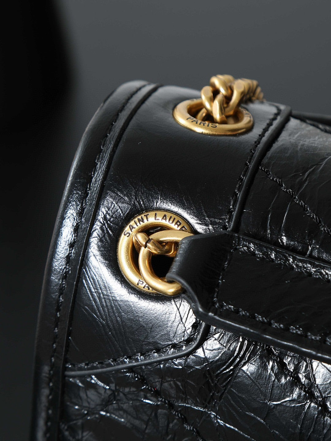 Saint Laurent Niki Baby shoulder bag in black crinkled glossed-leather