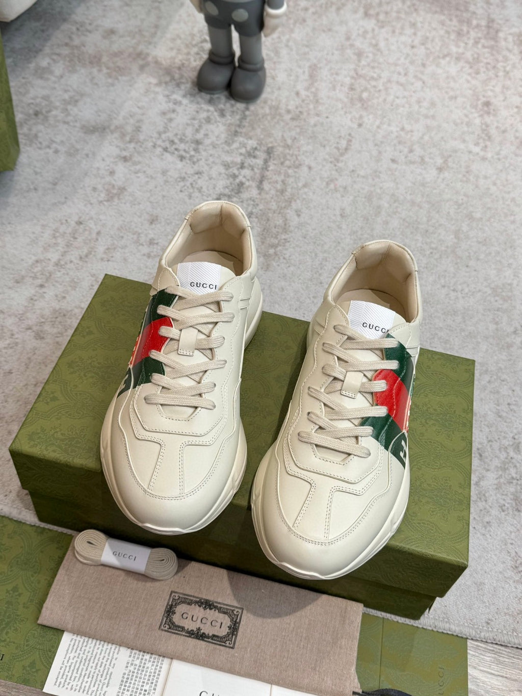 Gucci Men's Rhyton Retro Logo Sneakers in ivory leather with the signature green and red web print