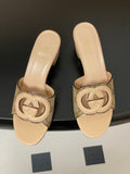 Gucci Interlocking G mules in a beige/caramel leather and fabric material