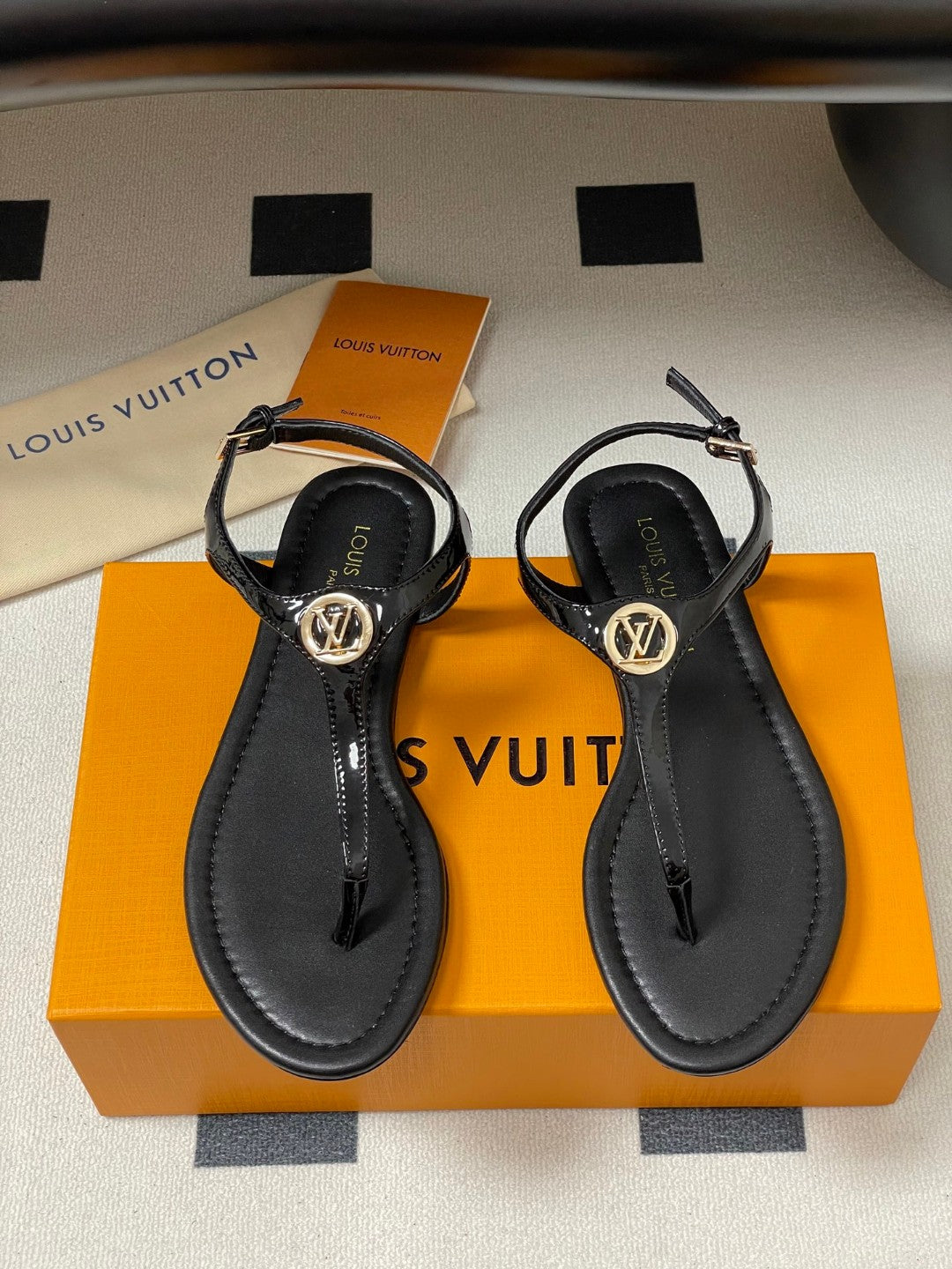 Louis Vuitton Sunkiss Flat Sandal in patent calf leather available in black, white, red, and silver
