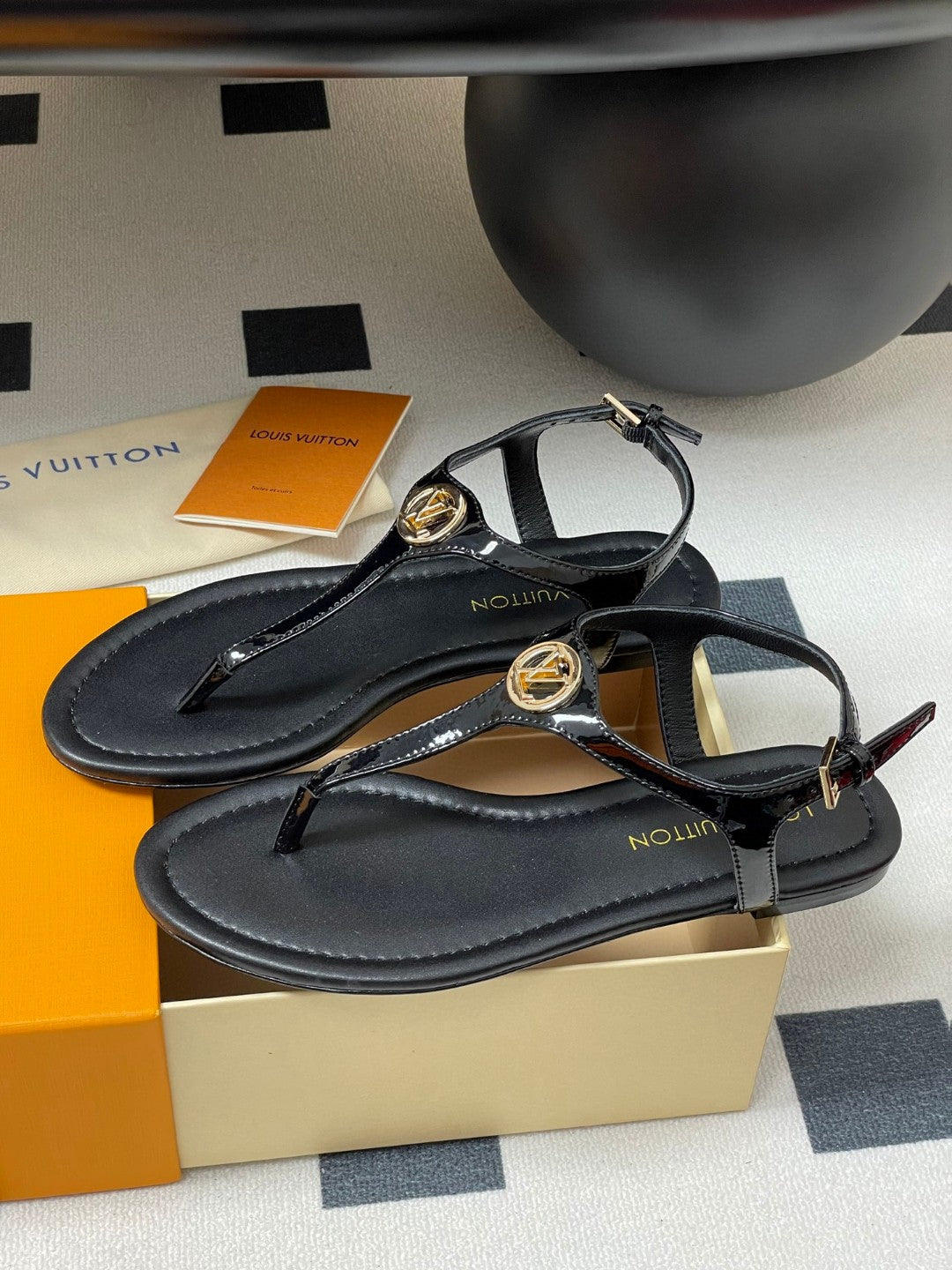 Louis Vuitton Sunkiss Flat Sandal in patent calf leather available in black, white, red, and silver