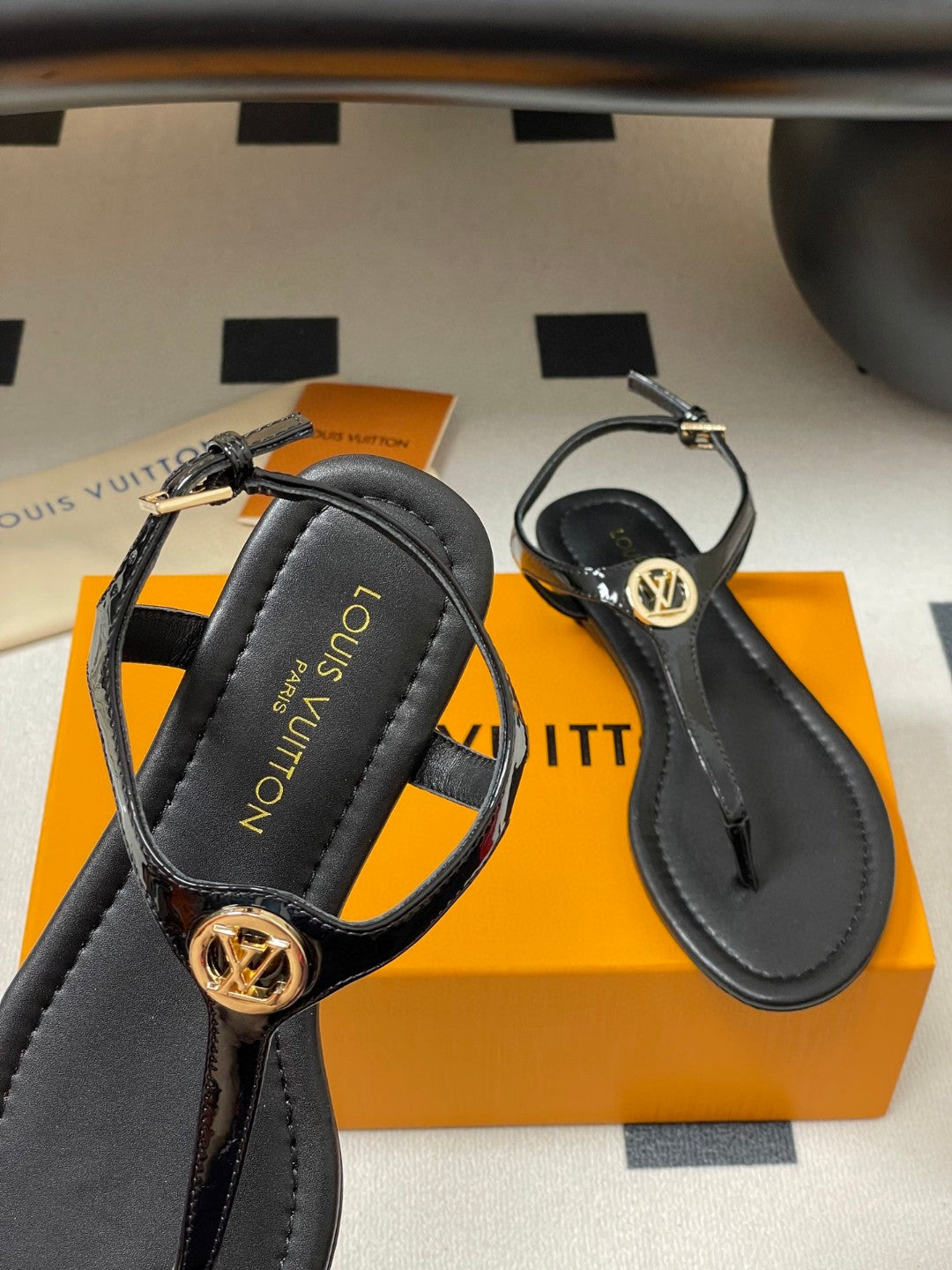 Louis Vuitton Sunkiss Flat Sandal in patent calf leather available in black, white, red, and silver