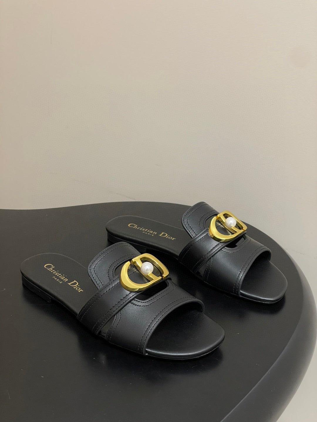 Christian Dior 30 Montaigne slide in black calfskin with a gold-finish metal 'CD' signature