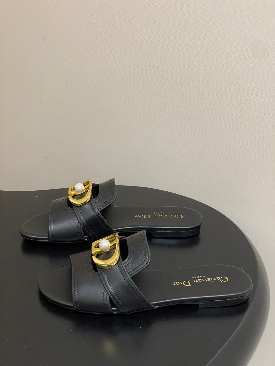 Christian Dior 30 Montaigne slide in black calfskin with a gold-finish metal 'CD' signature