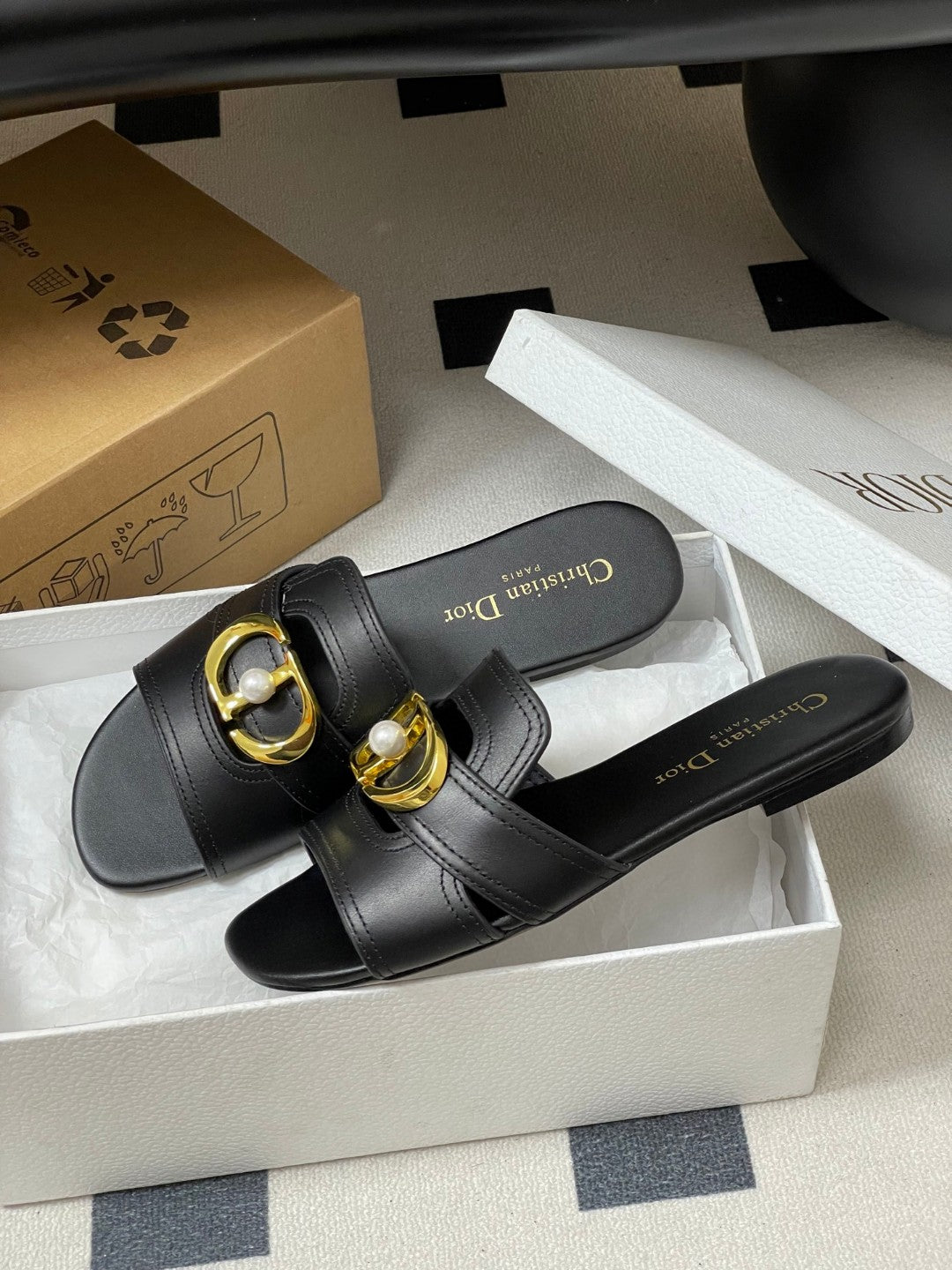 Christian Dior 30 Montaigne slide in black calfskin with a gold-finish metal 'CD' signature