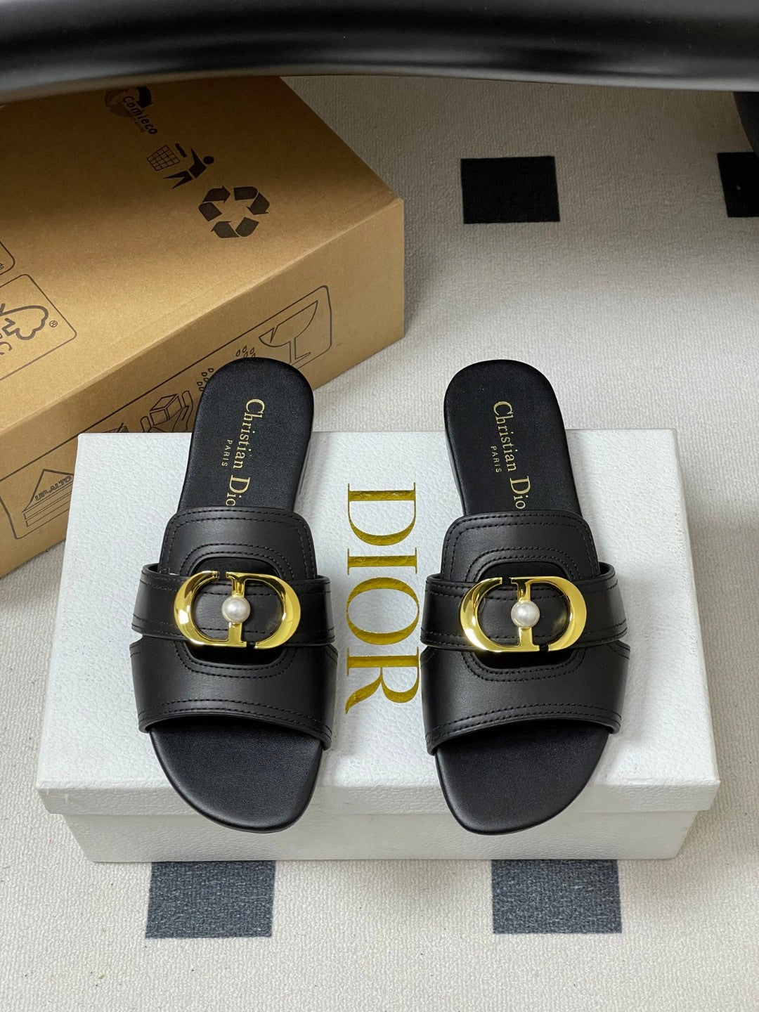Christian Dior 30 Montaigne slide in black calfskin with a gold-finish metal 'CD' signature