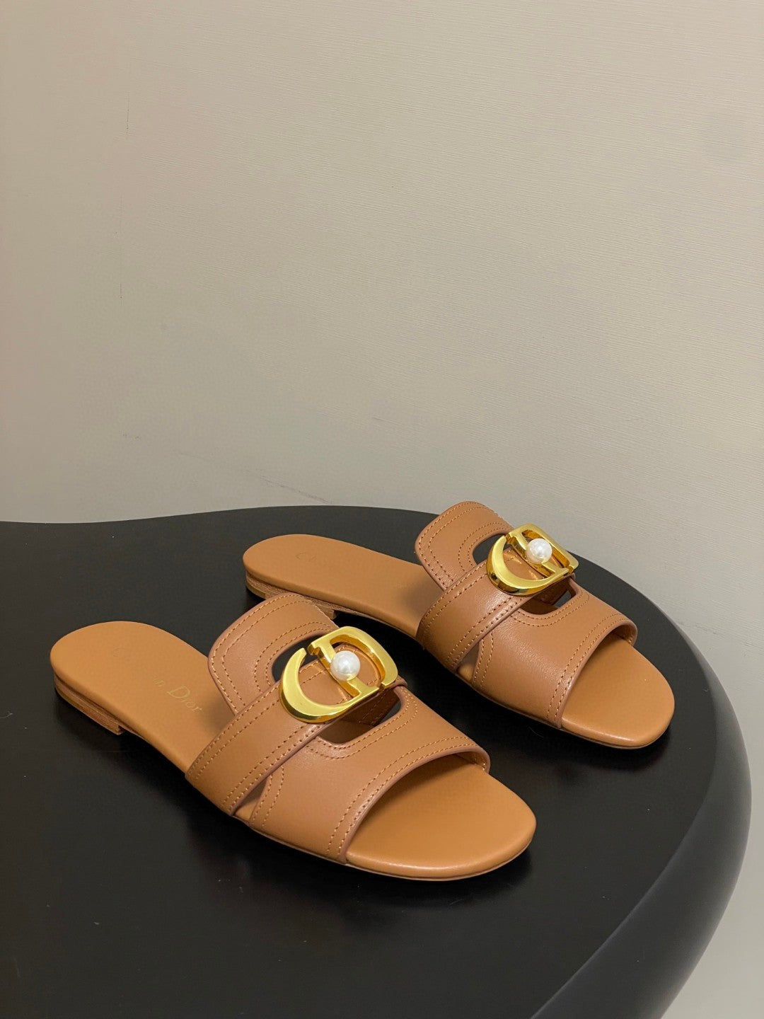 Dior 30 Montaigne flat slide sandals in beige calfskin leather with a gold-finish metal "CD" signature