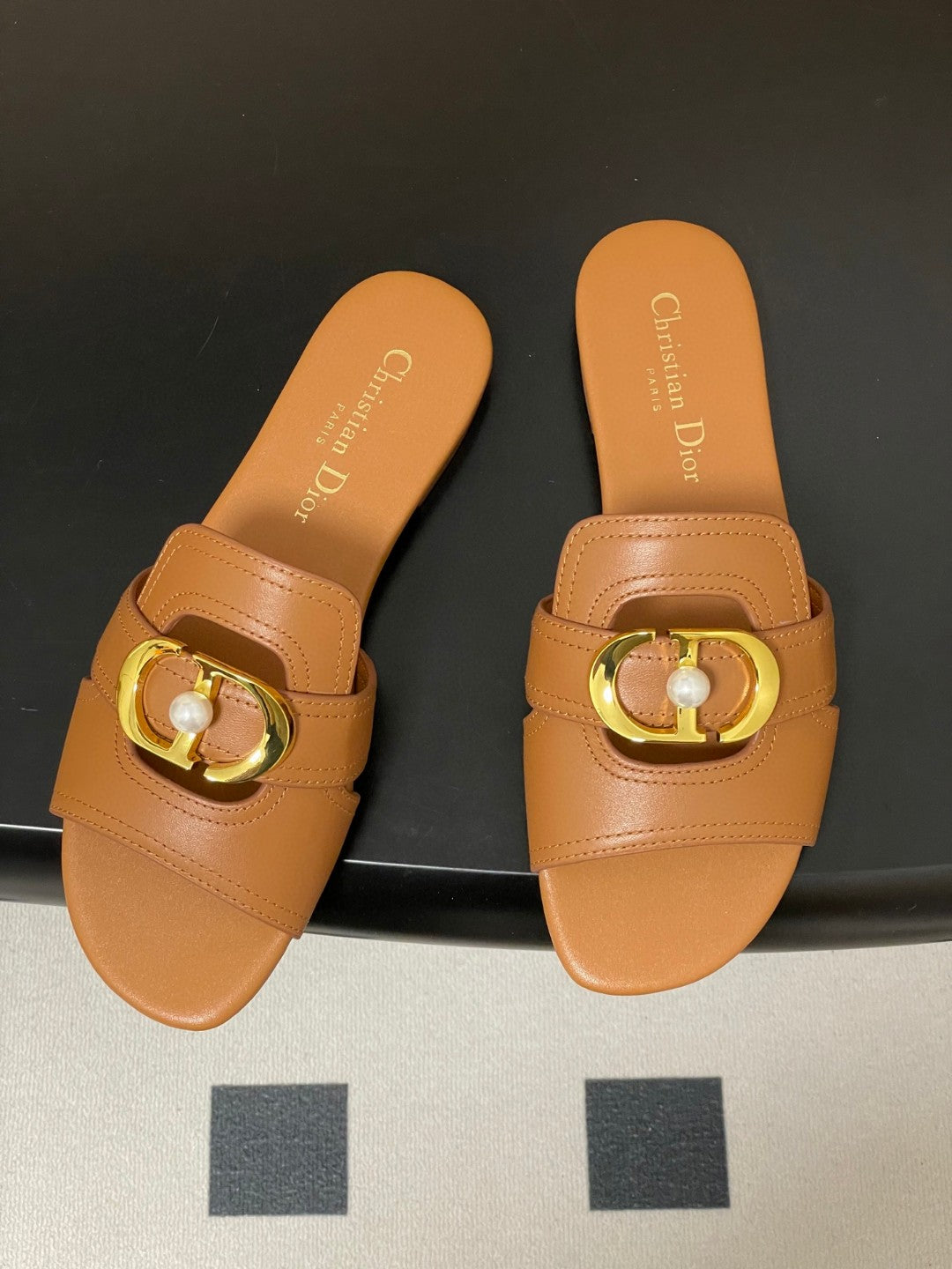 Dior 30 Montaigne flat slide sandals in beige calfskin leather with a gold-finish metal "CD" signature