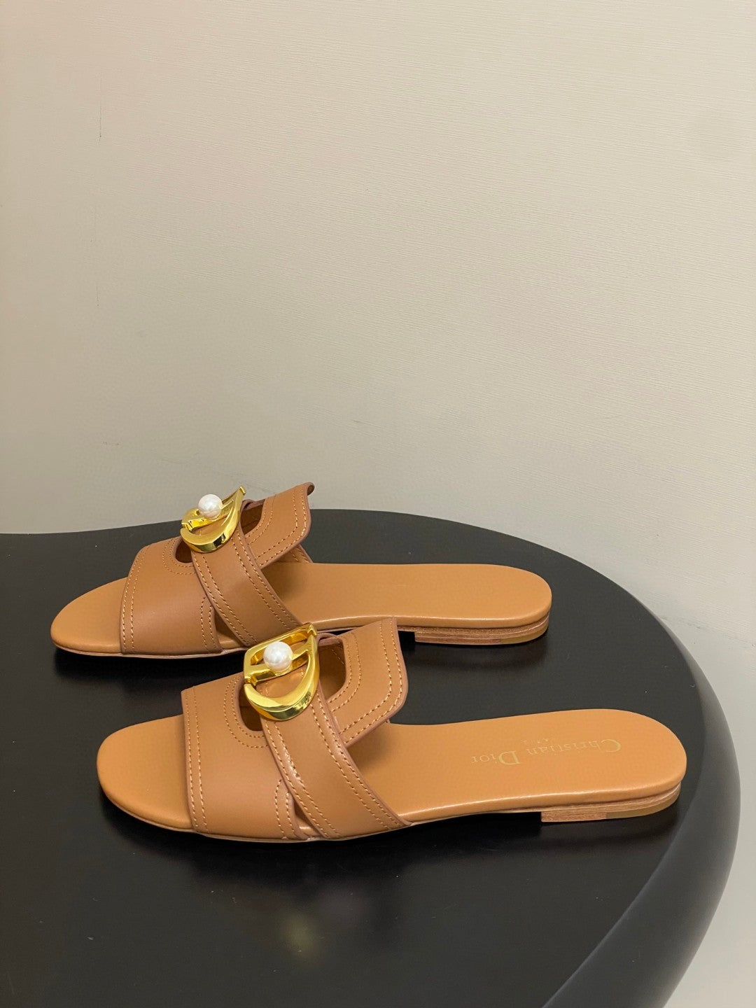 Dior 30 Montaigne flat slide sandals in beige calfskin leather with a gold-finish metal "CD" signature