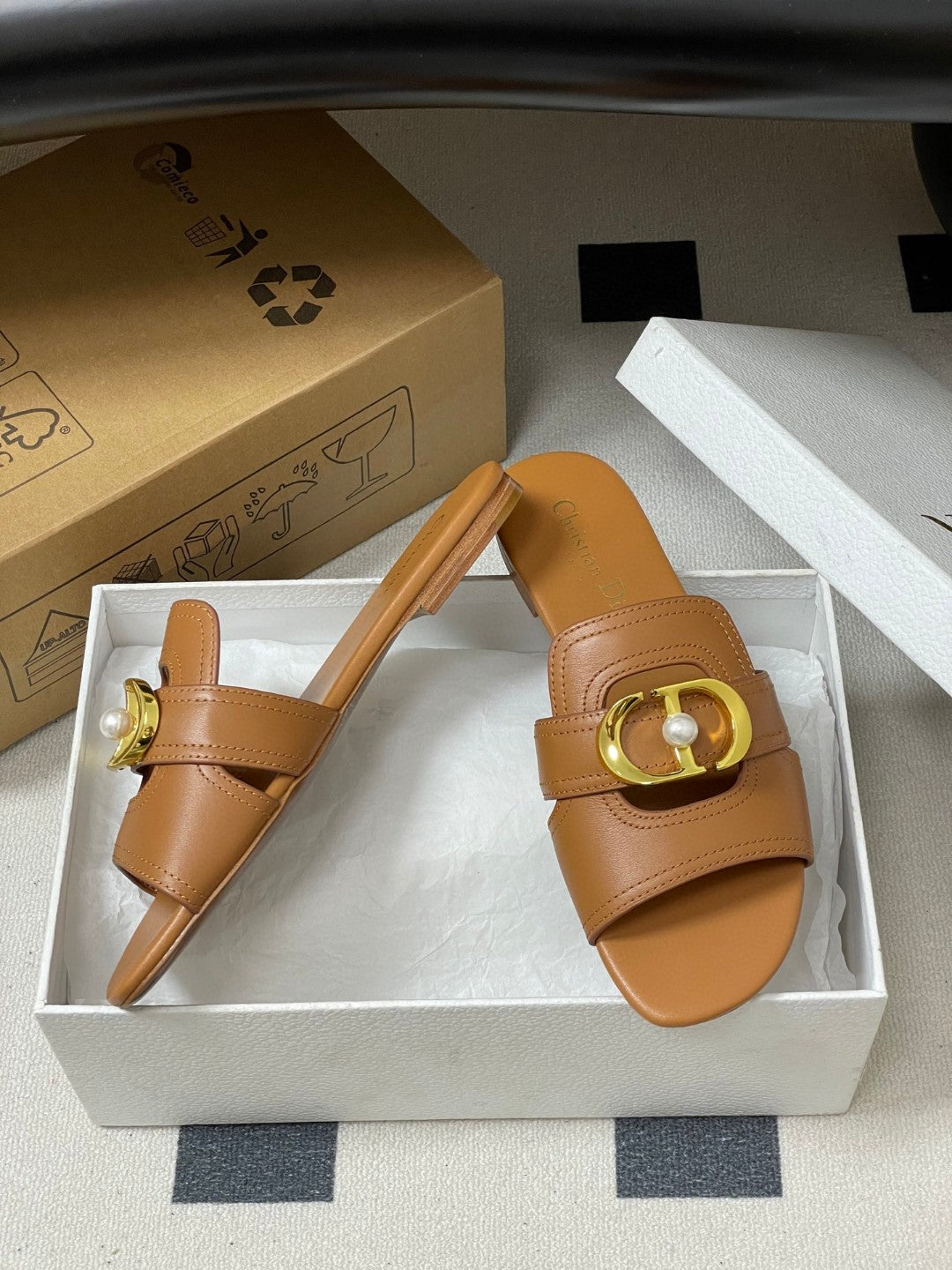 Dior 30 Montaigne flat slide sandals in beige calfskin leather with a gold-finish metal "CD" signature