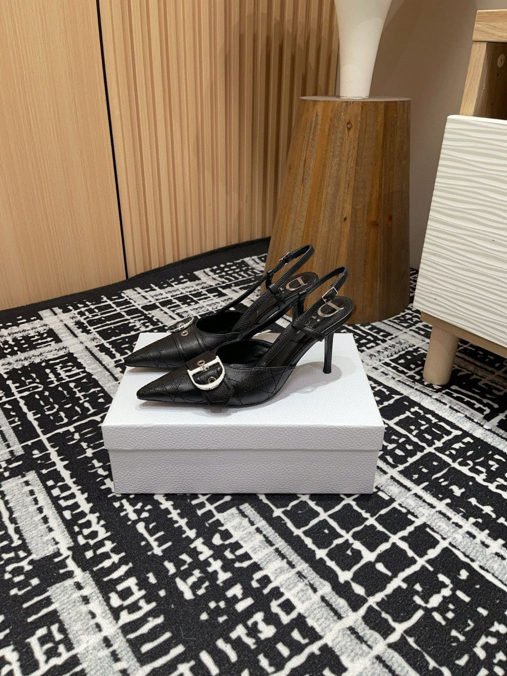 black Dior pumps with a buckle detail