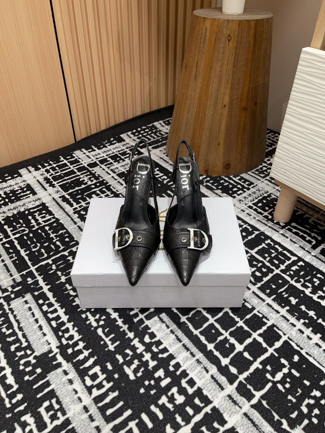 black Dior pumps with a buckle detail