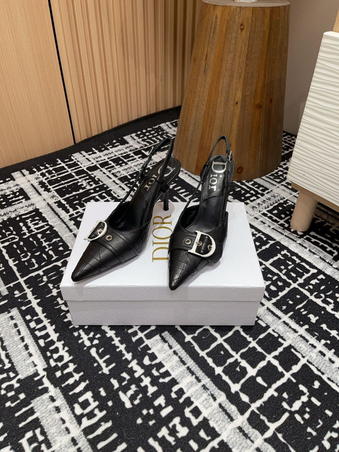 black Dior pumps with a buckle detail