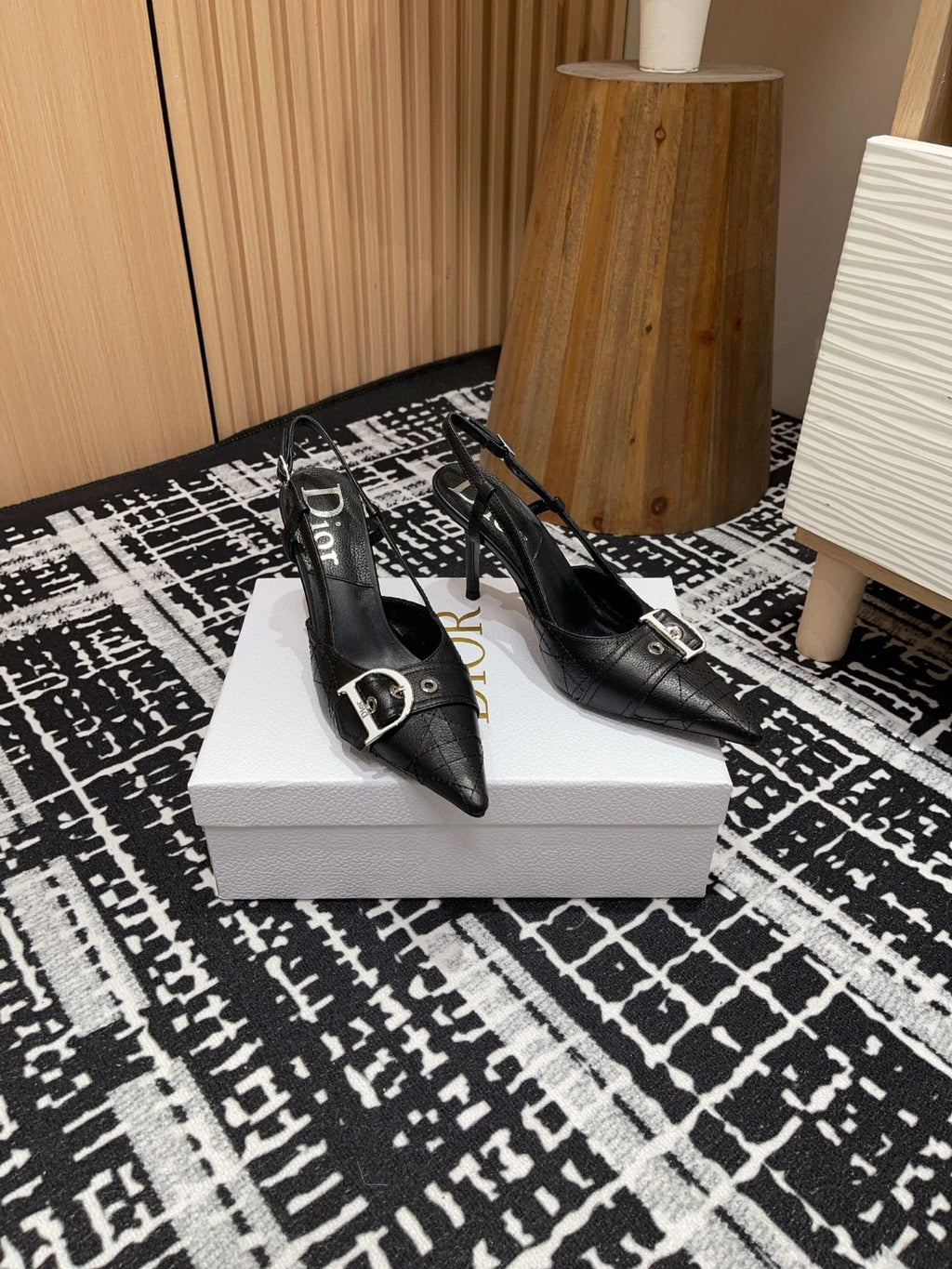 black Dior pumps with a buckle detail