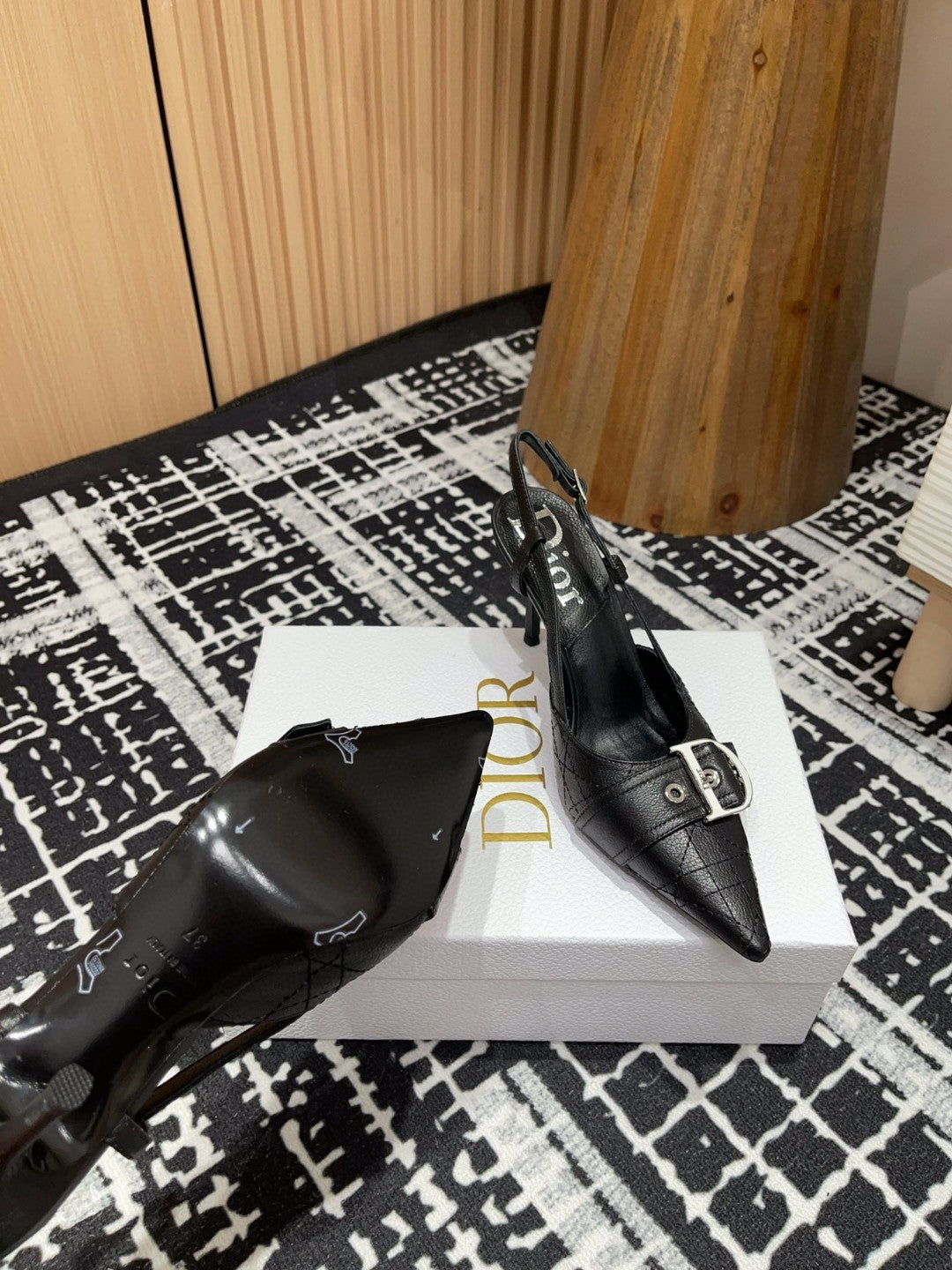 black Dior pumps with a buckle detail