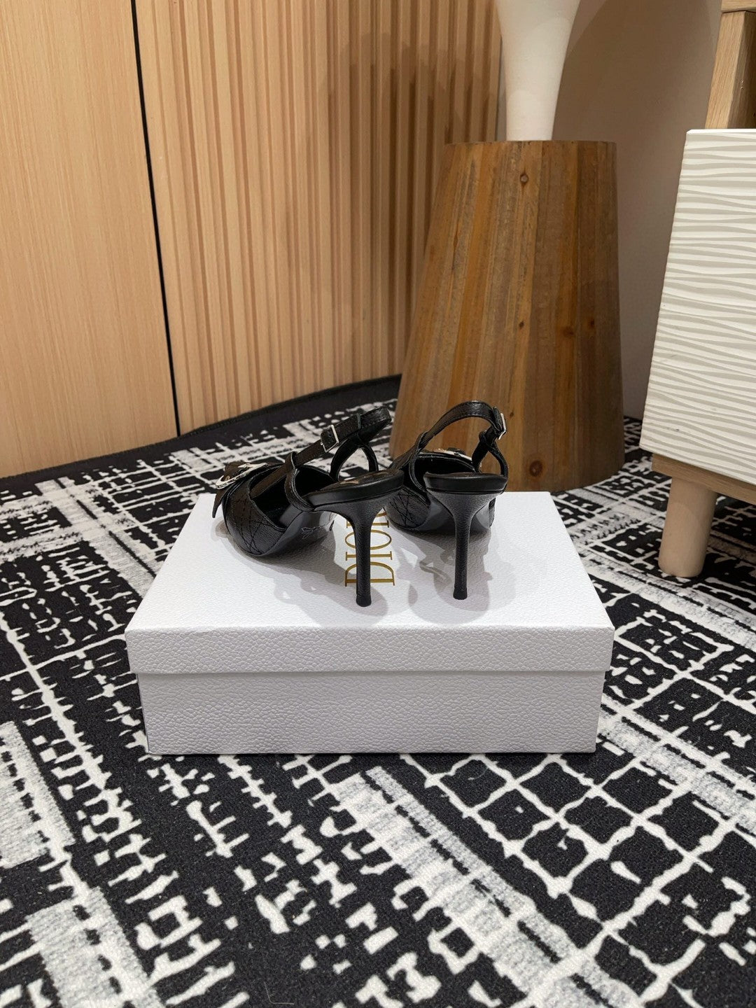 black Dior pumps with a buckle detail