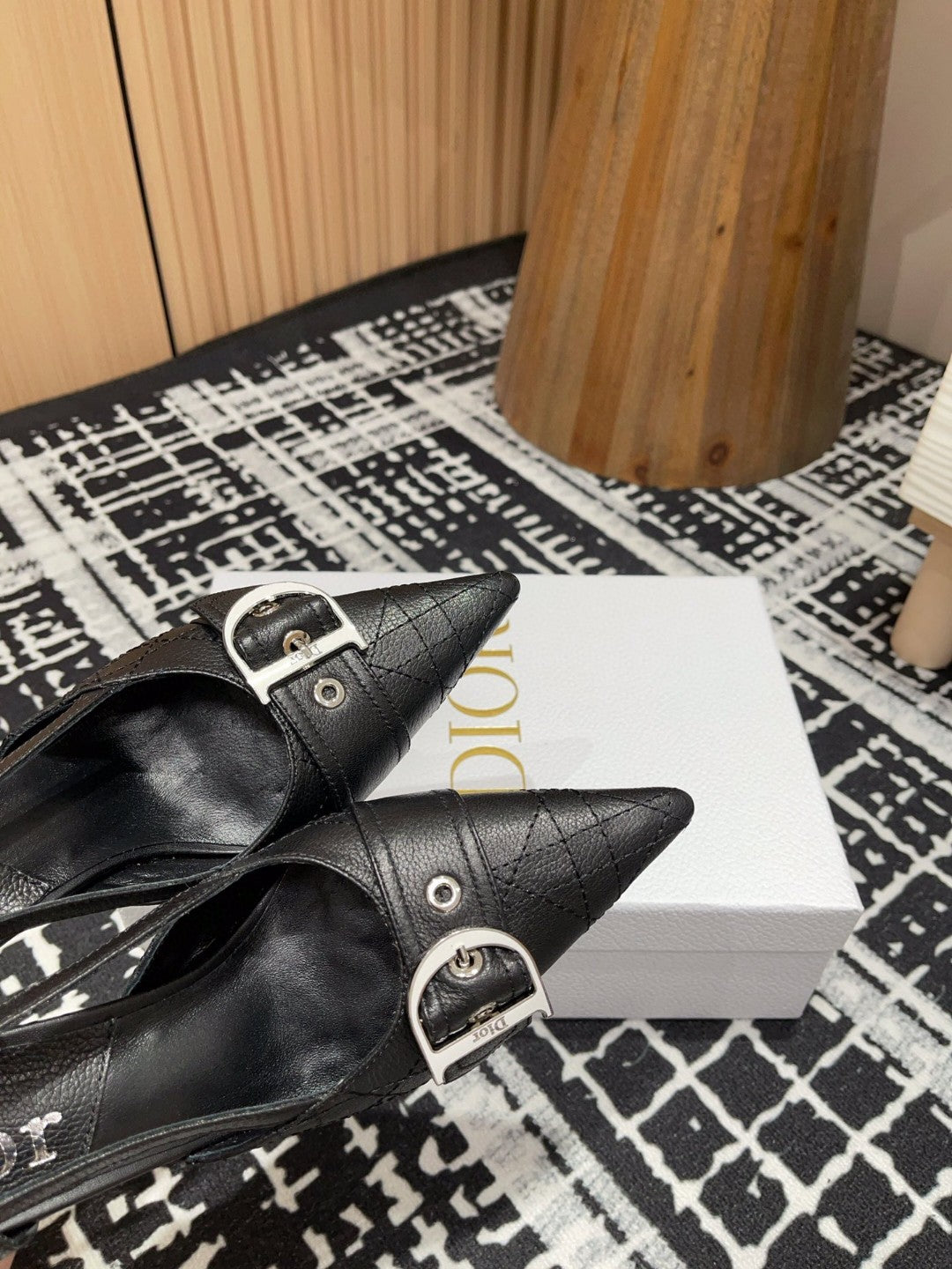 black Dior pumps with a buckle detail