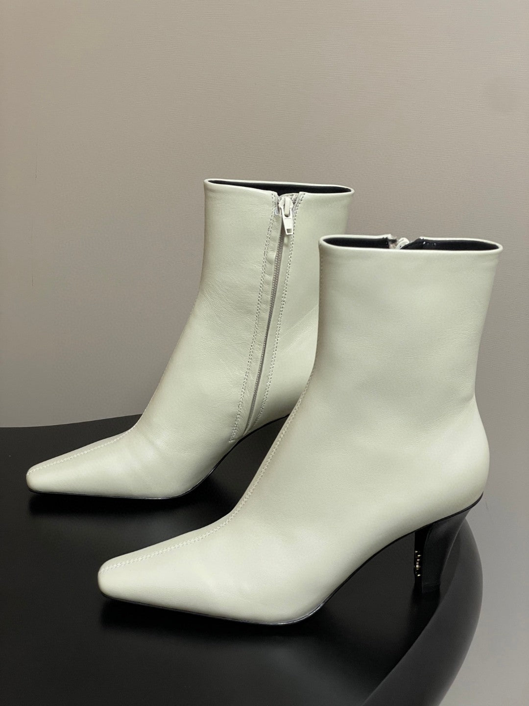 Saint Laurent Jill ankle boots in off-white smooth leather with a square pointed toe and a tapered heel featuring an inner Cassandre logo