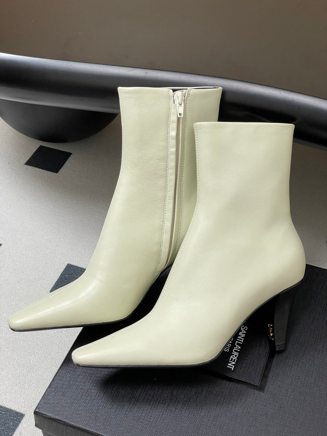 Saint Laurent Jill ankle boots in off-white smooth leather with a square pointed toe and a tapered heel featuring an inner Cassandre logo