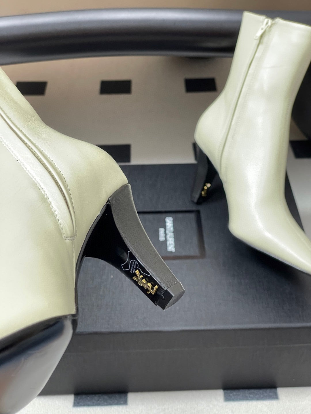 Saint Laurent Jill ankle boots in off-white smooth leather with a square pointed toe and a tapered heel featuring an inner Cassandre logo