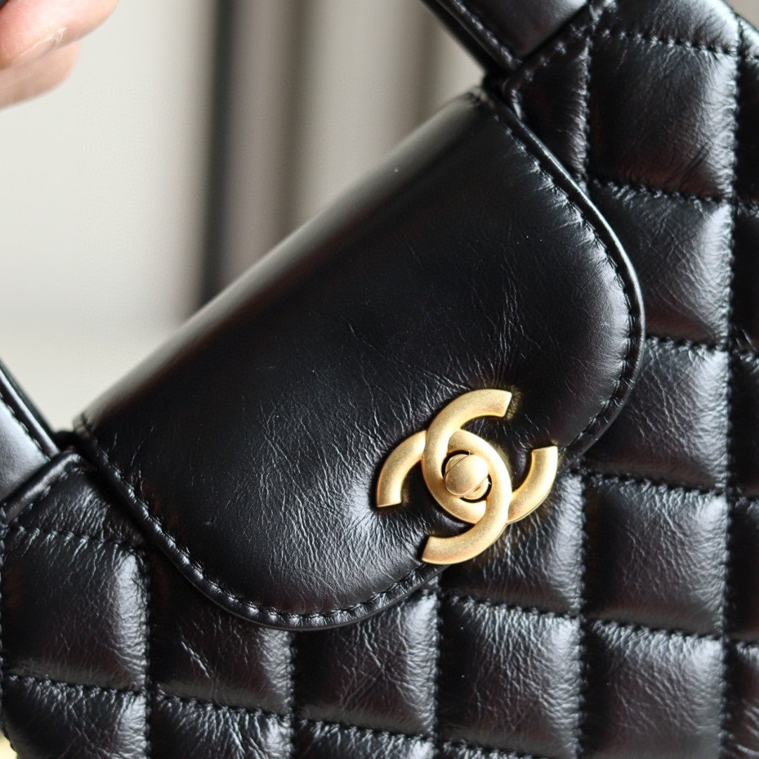 Chanel Mini Kelly bag in black calfskin with gold-tone metal hardware