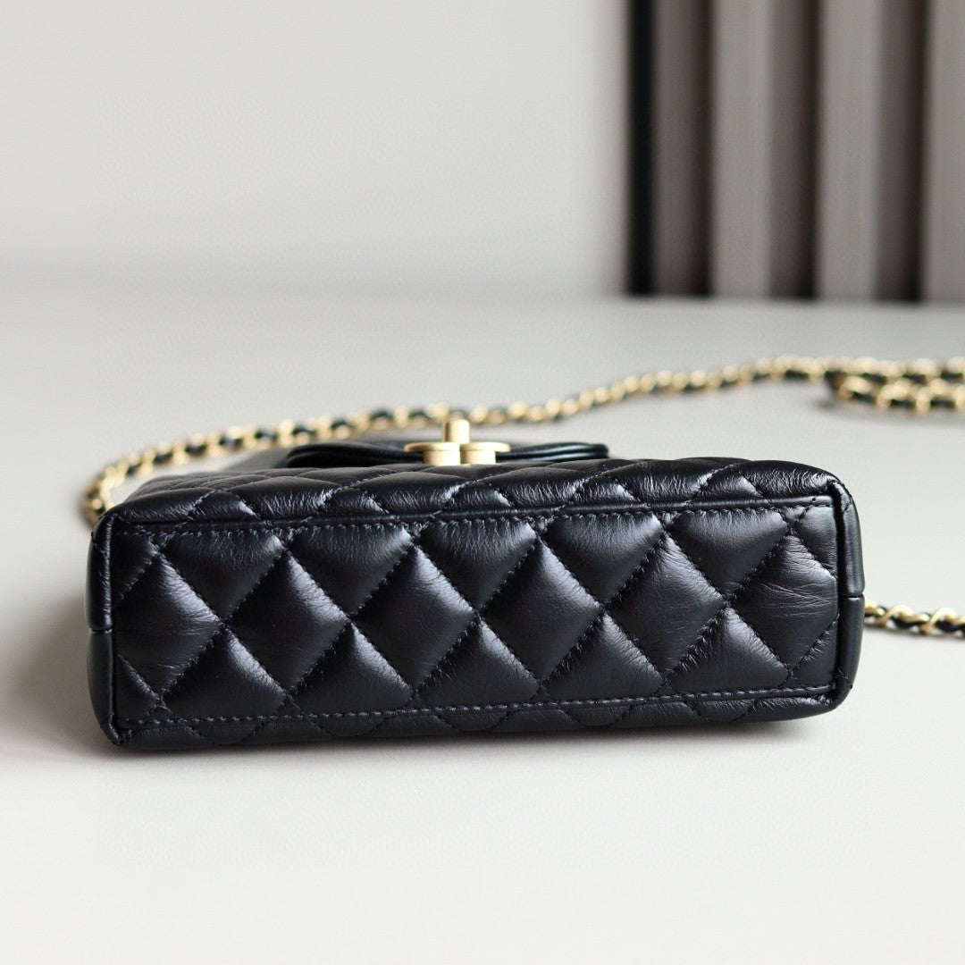 Chanel Mini Kelly bag in black calfskin with gold-tone metal hardware