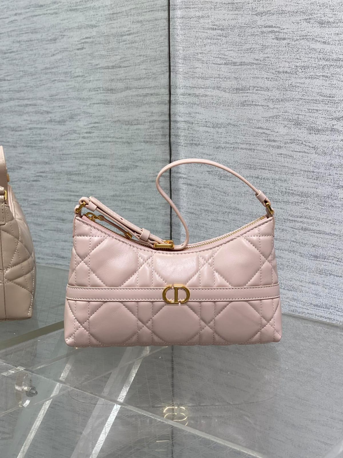 Dior Miss Caro mini hobo shoulder bag in black Macrocannage lambskin with a gold-finish metal CD signature and chain strap.