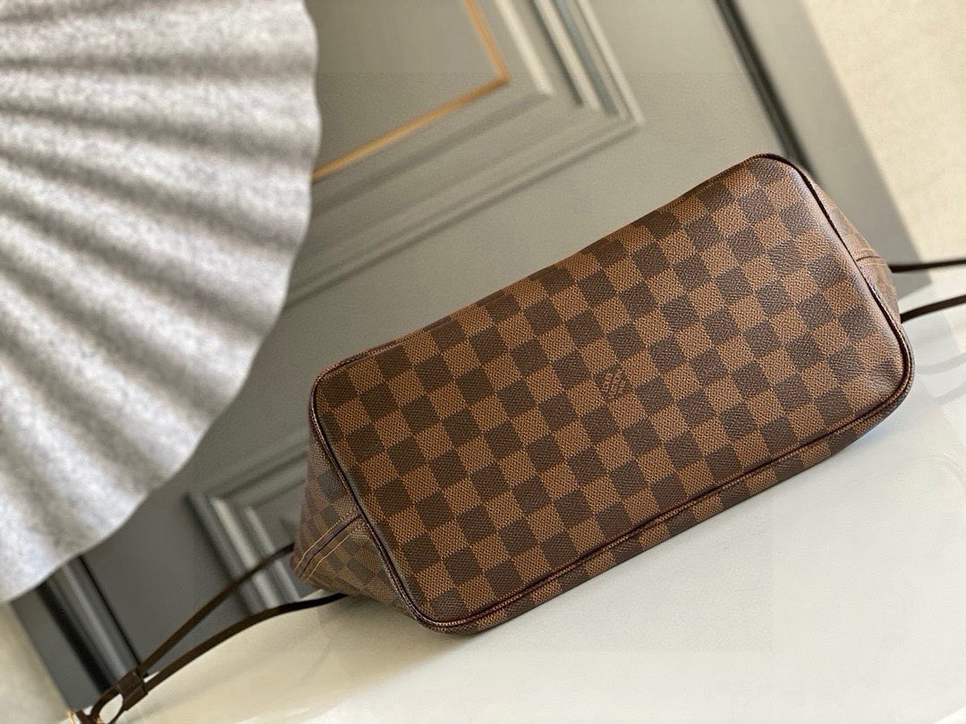 Louis Vuitton Neverfull MM tote bag in the Damier Ebene canvas with a red interior lining