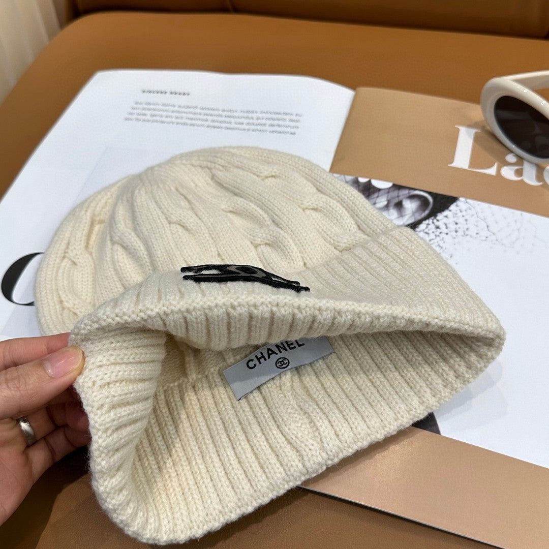 Chanel knit beanie in white with a black CC logo