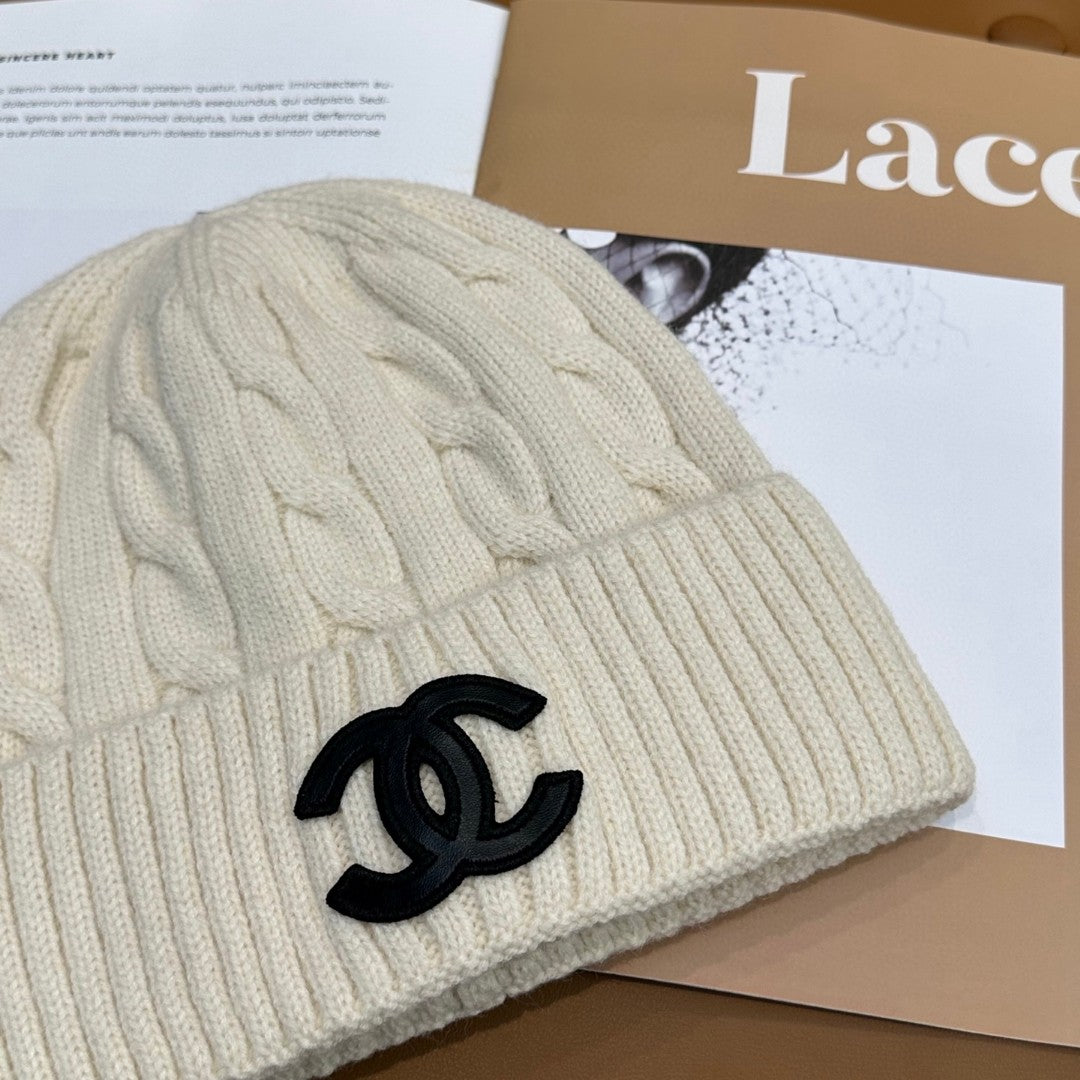 Chanel knit beanie in white with a black CC logo
